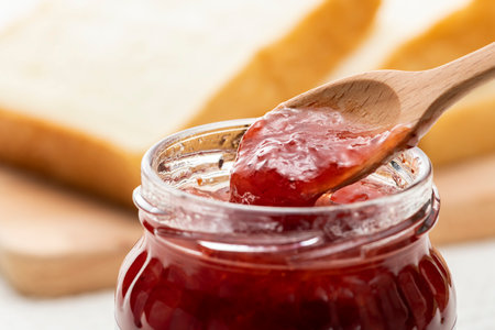 Strawberry jam in a bottle on the tableの写真素材