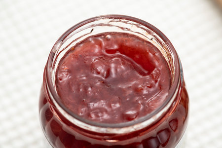 Strawberry jam in a bottle on the tableの写真素材
