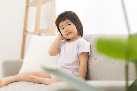 Little girl talking on smartphoneの写真素材
