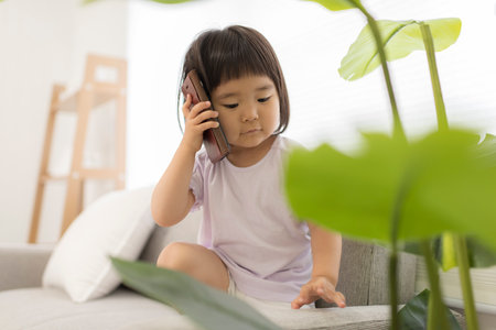 Little girl talking on smartphoneの写真素材