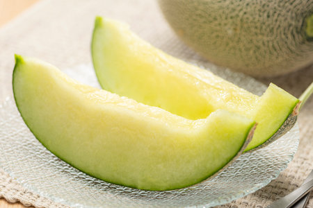 Fresh green melon cut on the tableの写真素材