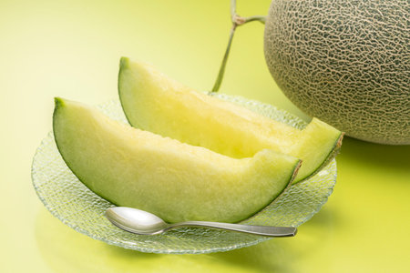 Eat the cut green melon with a spoonの写真素材