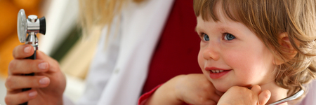 Little child with stethoscope at doctor reception. Physical exam, cute infant portrait, baby aid, healthy lifestyle, ward round, child sickness specialist, clinic test, pulse conceptの写真素材