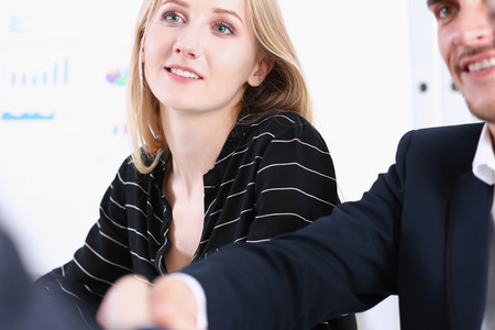Greup business people shake hands as hello in office closeup. Friend welcome, introduction, greet or thanks gesture, product advertisement, partnership approval, arm, strike a bargain on deal conceptの写真素材