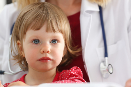 Little child at pediatrician reception. Physical exam appointment, cute infant portrait, baby aid, healthy lifestyle, ward round, child sickness, clinic test, high quality and trust conceptの写真素材