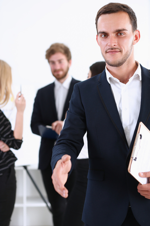 Businessman offer hand to shake as hello closeup isolated on white. Serious business, friendly support service, excellent prospect, introduction or thanks gesture, gratitude, invite to participate conceptの写真素材