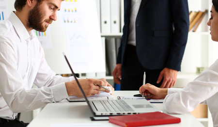 Group of people deliberate on white board problem in office portrait. Graph consult, idea participate, creative talk, review situation job, client document explain, train, successful decision conceptの写真素材