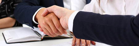 Man in suit shake hand as hello in office closeup. Friend welcome, mediation offer, positive introduction, greet or thanks gesture, summit participate approval, motivation, strike arm bargain conceptの写真素材