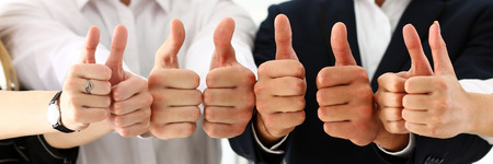 Group of people show OK or confirm with thumb up during conference closeup. High level quality product, serious offer, excellent education, mediation solution, creative advisor participation conceptの写真素材