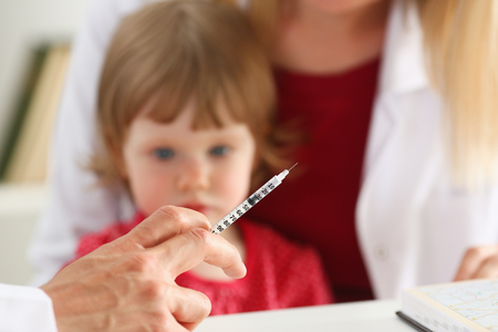 Little scared child at doctor reception make insulin shot. Physical exam, cute baby aid, healthy lifestyle, child sickness specialist, hepatitis, hiv, aids, virus protection, flu remedy, drug conceptの写真素材