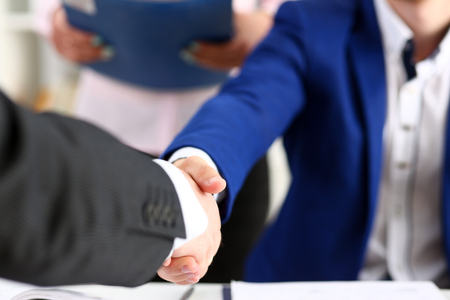 Man in suit shake hand as hello in office closeup. Friend welcome, mediation offer, positive introduction, greet or thanks gesture, summit participate approval, motivation, strike arm bargain conceptの写真素材