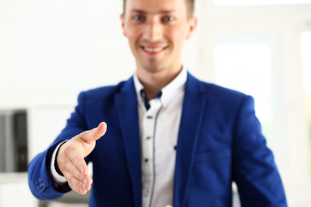 Businessman offer hand to shake as hello in office closeup. Serious business, friendly support service, excellent prospect, introduction or thanks gesture, gratitude, invite to participate conceptの写真素材