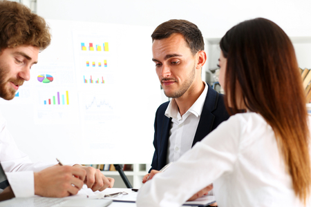 Group of people deliberate on white board problem in office portrait. Graph consult, idea participate, creative talk, review situation job, document explain, train, successful decision conceptの写真素材