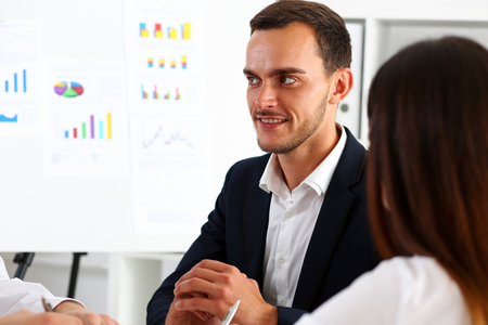 Group of people deliberate on white board problem in office portrait. Graph consult, idea participate, creative talk, review situation job, client document explain, train, successful decision conceptの写真素材