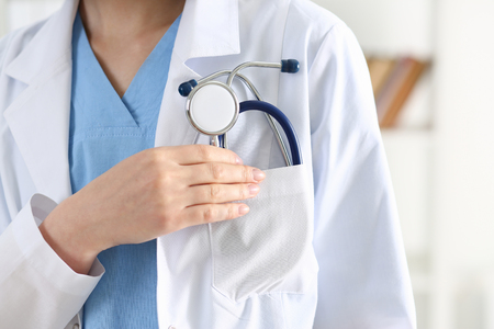 Doctor chest with stethoscope in pocket closeup. Physical and disease prevention, patient exam, 911, ward round, prescribe remedy, pulse measure, healthy lifestyle, veterinarian education conceptの写真素材