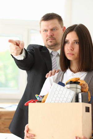 Angry yelling boss point arm to exit dismissing sad worker with stuff box portrait. Bad news, pack and carry belongings hopeless, human resources, staff reduction, hr get upset, give sack conceptの写真素材