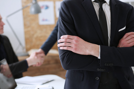 Hands of businessman at workplace crossed on chest. White collar worker at workspace shake hands, exchange market, job offer, certified public accountant, internal Revenue officer conceptの写真素材