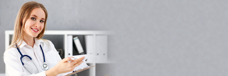 Beautiful smiling female doctor stand in office portrait. Physical and patient disease prevention, exam, er, ward round, 911, prescribe remedy, healthy lifestyle, consultant, nurse profession conceptのeditorial素材