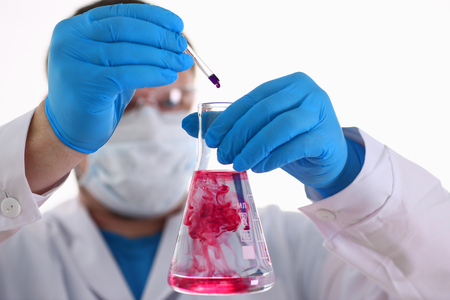 A specialist in the laboratory for taking samples from people conducts a blood test for resistance to viruses and microorganisms, for example, the danger and infection of the danger of a mass epidemicの写真素材