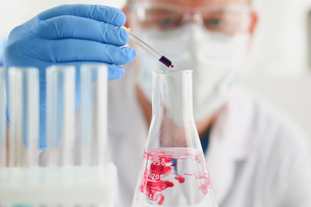 A specialist in the laboratory for taking samples from people conducts a blood test for resistance to viruses and microorganisms, for example, the danger and infection of the danger of a mass epidemicの写真素材