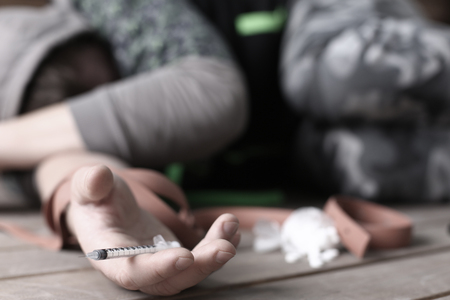 Social advertising on the topic of drug addiction. The young drug addict lost seven, business, everything turned from him and he is not important for societyの写真素材