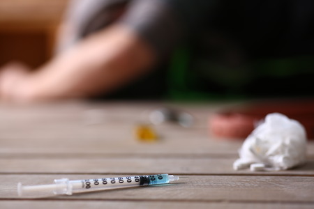 Social advertising on the topic of drug addiction. The young drug addict lost seven, business, everything turned from him and he is not important for societyの写真素材