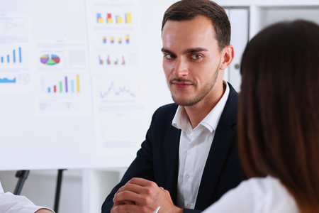 Group of people deliberate on white board problem in office portrait. Graph consult, idea participate, creative talk, review situation job, client document explain, train, successful decision conceptの写真素材