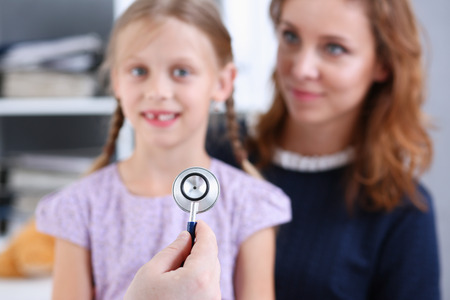 Little child with mother at pediatrician reception. Physical exam, cute infant portrait, baby aid, healthy lifestyle, ward round, child sickness, clinic test, high quality and trust conceptの写真素材