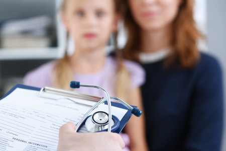 Little child with mother at pediatrician reception. Physical exam, cute infant portrait, baby aid, healthy lifestyle, ward round, child sickness, clinic test, high quality and trust conceptの写真素材