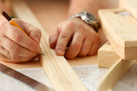 Arms of worker making structure plan on scaled paper closeup. Manual job, DIY inspiration, improvement job, fix shop graphic, joinery startup, workplace idea, designer career, wooden bar, rulerの写真素材
