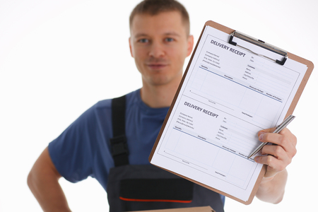 Specialist courier delivery service offers to fill the contract of cooperation to the client. Terms of delivery are agreed upon and signed by both parties with a pen in handの写真素材