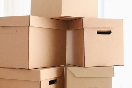 A lot of carton box of kraft color. Theme of moving the loading of unloading cargo delivery of goods from the Internet to the purchaser from the supplierの写真素材