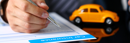 Male arm in suit sign insurance form lying on tableの写真素材