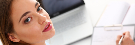 Female doctor hold hold in arm silver pen and padの写真素材