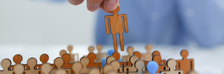 businessman in blue shirt move small human figureの写真素材