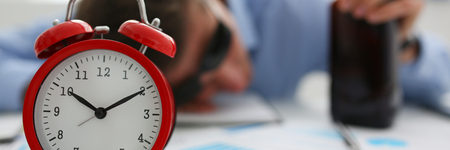 Businessman in blue shirt asleep at workの写真素材