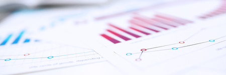 Group of people deliberate on problem with infographics closeup