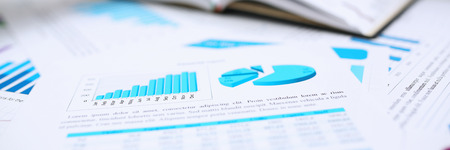 Male hands hold documents with financial statisticsの写真素材