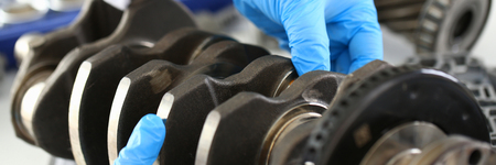 The mechanic of the service center for engine repair considers