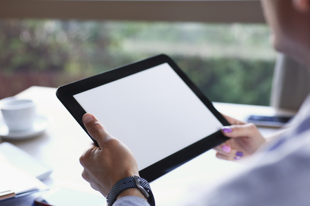 Businessman holding tablet in hand in cafeの写真素材