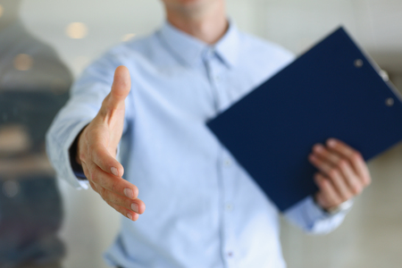 Businessman offer hand to shake as hello in officeの写真素材