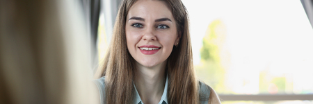 Beautiful smiling cheerful girl at workplaceの写真素材