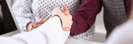 Man in suit shake hand as hello in officeの写真素材