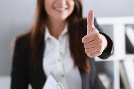 Beautiful smiling woman showing ok or approvalの写真素材