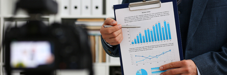 Male in suit and tie show stats graph padの写真素材