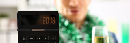 Man in suit hold in arm calculator with 2018 yearの写真素材