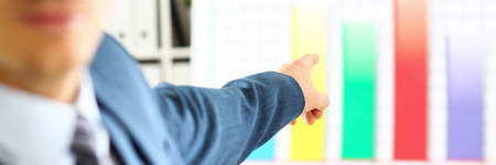 Man in suit point with arm in stats graphの写真素材