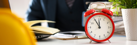 Red alarm clock shows late time closeup