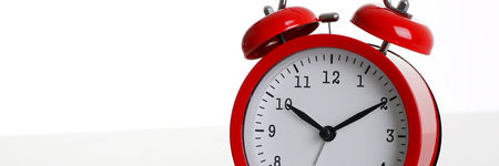 Red alarm clock isolated on white