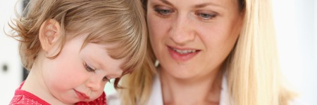 Little child with smarthone at doctorの写真素材